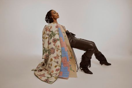 Frau von der Seite mit drei Mänteln übereinander